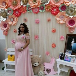 Marvelous Pregnant Woman In Pink Dress Standing Next To Backdrop With