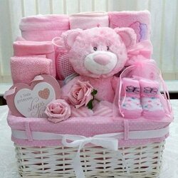 The Highest Quality Pink Teddy Bear Sitting In Basket Filled With Baby Items On Top Of